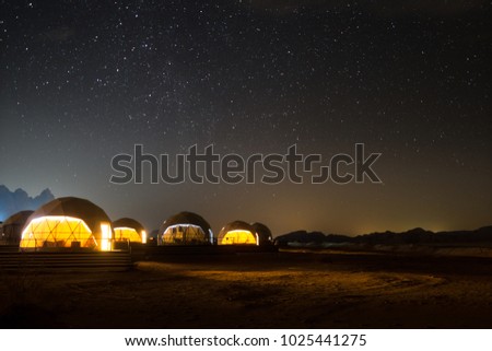 Stars above martian dome tents in Wadi Rum Desert, Jordan. 