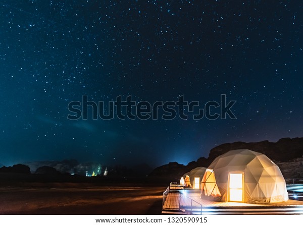 Stars above martian dome tents in Wadi Rum\
Desert, Jordan.