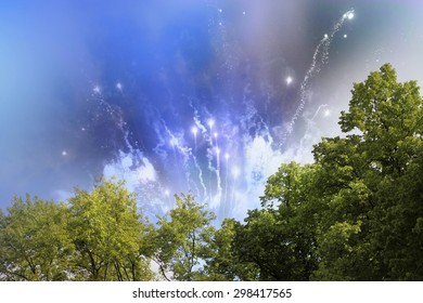 Stars And Lights Pattern Of Bright Day Time Fireworks Behind A Group Of Trees