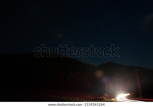 Stars and mountains\
and a car passing by.