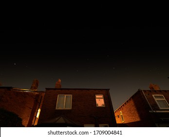 Stars Sparkle Clearly On A Cloudless Night Over Houses On A Street In Wakefield, Yorkshire.