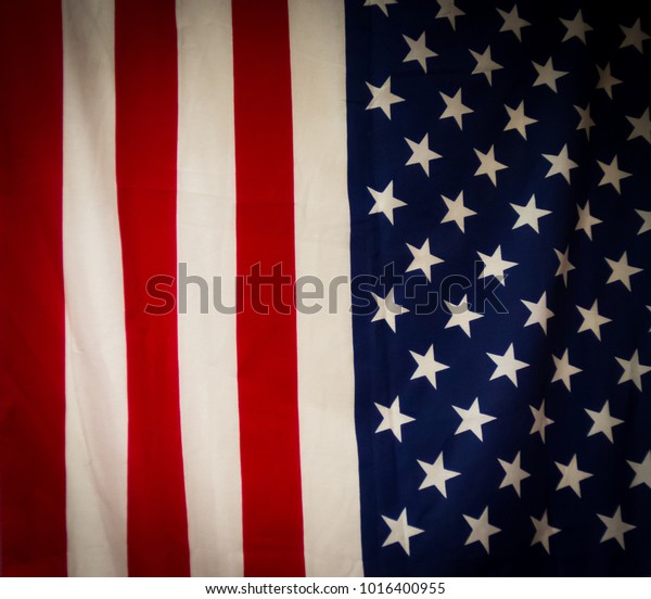 The stars\
and stripes of an American flag are pictured divided evenly and\
vertically.  It\'s a divided nation\
concept