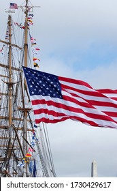 The Stars And Stripes On A Sailing Ships Waves Proudly Above A Revolutionary War Monument
