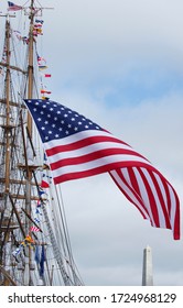  Star-Spangled Banner Billows Softly Off A Sailing Ship With Revolutionary War Monument In The Distance
