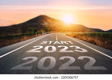 Start 2023 written on highway road in the middle of empty asphalt road of asphalt road at sunset.Concept of planning and challenge, business strategy, opportunity ,hope, new life change.for 2022-2023. - Shutterstock ID 2205306757