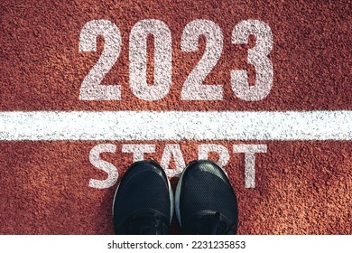 Start 2023 year concept, top view of man shoe on an athletics track engraved with the year 2023.Start of the new year 2023, goals and plans for the next year.Opportunity, challenge,Goal of Success - Shutterstock ID 2231235853