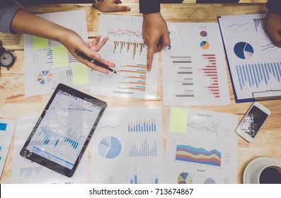 Start Up Business. People Meeting Point To Discuss The Graph Up And Down Of The Economy And Work On Table.Top View,Soft Focus