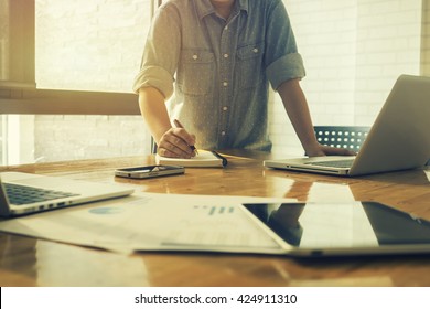 Start up businessman Determine Ideas Writing note ,People Meeting Design, working with calculator,business document laptop computer notebook,vintage tone - Shutterstock ID 424911310