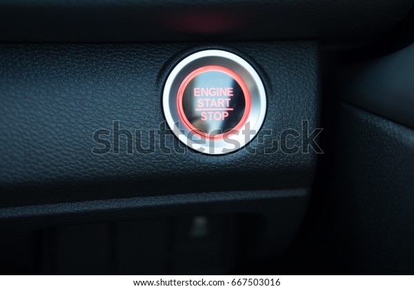 start button engine with orange light and have\
black leather console car interior detail. image for\
car,interior,transport and vehicle\
concept