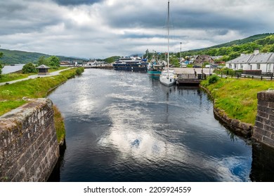 Start Of The Caledonian Canal,near Fort William And Ben Nevis,summer Evening As Sun Sets,reflections On The Canal Water,with Boats Waiting In Beautiful Light Shining Through Clouds.