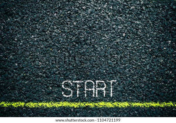 Start Chalk Writing and Yellow Line on\
Asphalt Ground, Suitable for Business\
Concept.
