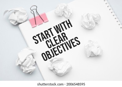 Start With Clear Objectives. Blank Sheet Of Paper, Red Paper Clip, Word Ideas And Crumpled Paper Wads