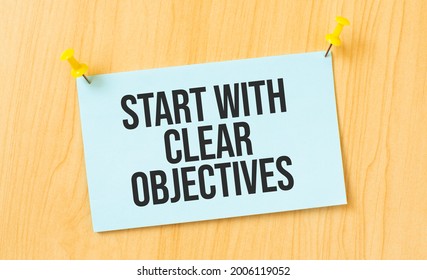 Start With Clear Objectives Sign Written On Sticky Note Pinned On Wooden Wall