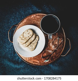 Start of the day essentials with a planner, coffee and biscuits.