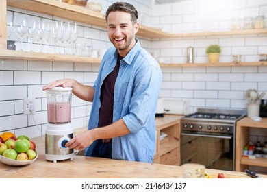 I start my day with a vitamin boost. Shot of a young man making a health smoothie at home. - Powered by Shutterstock