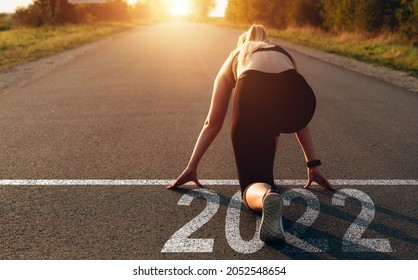 Start the New Year 2022.  New Goals, Plans and Visions for Next Year 2022. Sporty woman waiting at the Starting line.