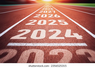 Start of new year. Changes of year 2024, 2025, 2026 on Running track. Concept of new ideas starting in new year, planning along with setting objectives to set KPI goals for success in life.