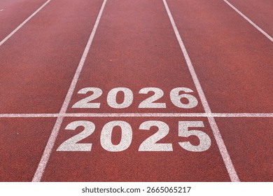 Start of new year. Changes of year 2025, 2026, 2027 on Running track. Concept of new ideas starting in new year, planning along with setting objectives to set KPI goals for success in life.