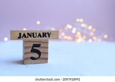 Start new year, Cube calendar with date January 5th, Wooden calendar with date on bokeh lights background.