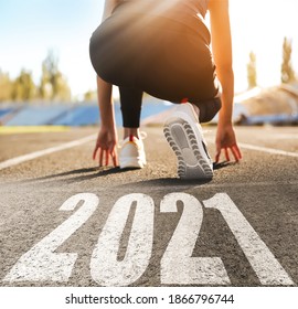 Start New Year With Fresh Vision And Ideas. Sporty Woman Ready For Running Near 2021 Numbers On Road, Closeup