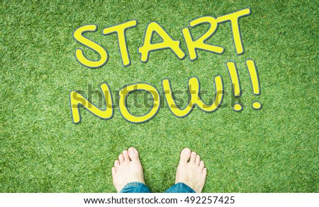 Start now concept text with human foot on green grass