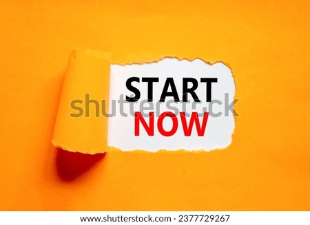 Start now symbol. Concept words Start now on beautiful white paper. Beautiful orange table orange background. Business marketing, motivational start now concept. Copy space.