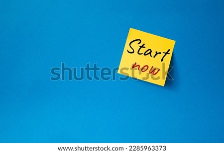 Start now symbol. Orange steaky note with words Start now. Beautiful blue background. Business and Start now concept. Copy space.