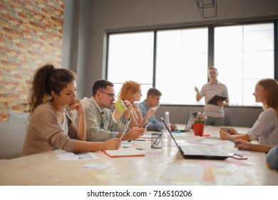 Start Up Programming Team. Website Designer Working Digital Tablet Dock Keyboard And Computer Laptop With Smart Phone And Compact Server On Mable Desk,light Effect, Red Cups.