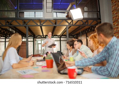 Start Up Programming Team. Website Designer Working Digital Tablet Dock Keyboard And Computer Laptop With Smart Phone And Compact Server On Mable Desk,light Effect, Red Cups.