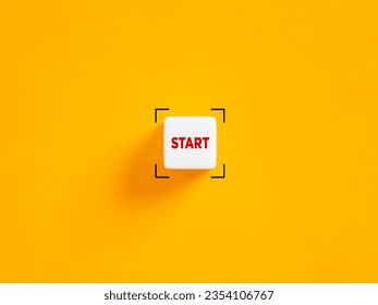Start push button. Starting a new career, project or life concept. Business startup. The word start on white cube on yellow background.