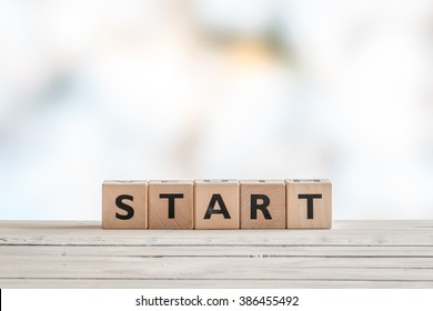 Start Sign Made With Cubes On A Wooden Table