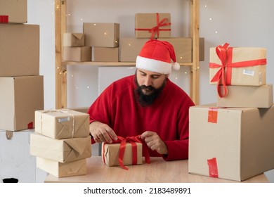 start up small business owner packing cardboard box at workplace. seller Santa Claus prepare parcel box of product for deliver to customer. Online selling, Christmas sale, commerce, shipping concept