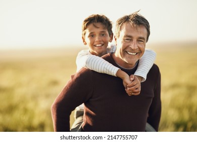 Start Spending More Time Outdoors With Your Kids. Shot Of A Mature Man Carrying His Son On His Back.