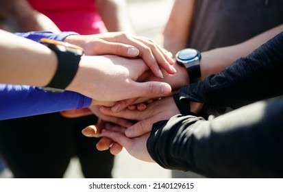 Start stacking. Closeup of a group of unrecognizable peoples hands forming a huddle outside during the day.