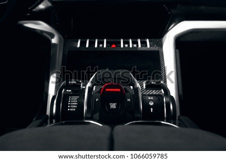 start and stop button at dark car interior 