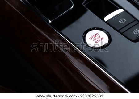 Start stop engine button Interior of modern luxury car. Details of automatic transmission gear shift, multimedia control system, car control panel, Air Vent Red emergency button and dashboard inside