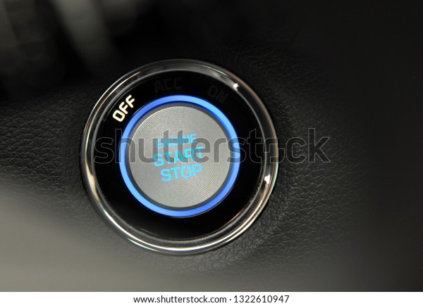 Start stop\
engine button on a modern car\
dashboard
