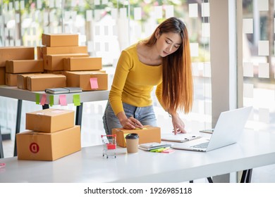  Start up successful small business owner,working from home with laptop computer and online purchase shopping order and box packaging on table (new normal concept)  - Shutterstock ID 1926985118