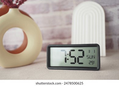 Start your day right by placing a digital alarm clock on a table to wake up in the morning