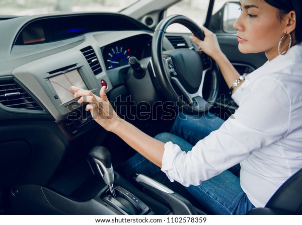 Starting of a Asian woman journey with her car focus\
on hand
