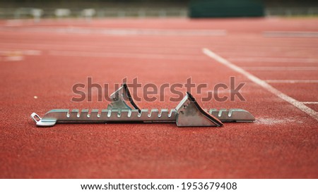 Starting block on empty running track with no people