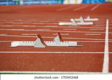 Starting Blocks On Orange Turf 