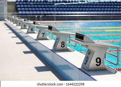 Starting Blocks In A Row In A Open Air Swimming Pool