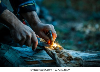 Starting A Campfire With A Fire Striker While Wilderness Camping - Powered by Shutterstock