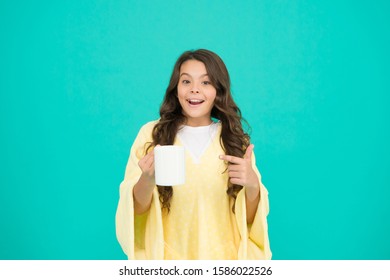 Starting Day With Breakfast. Small Kid Turquoise Background. Little Girl Drink Cocoa Or Milk Before Sleeping. Cosy And Fluffy Pajama. Feeling Comfortable At Home. Happy Girl With Hot Dring In Cup.