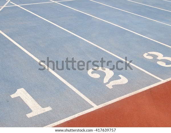Starting lines on\
running track at playground\
