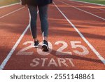 Starting to the new year 2025. woman preparing to start on an athletics track engraved with the year 2025. idea for planning, goals and New Year