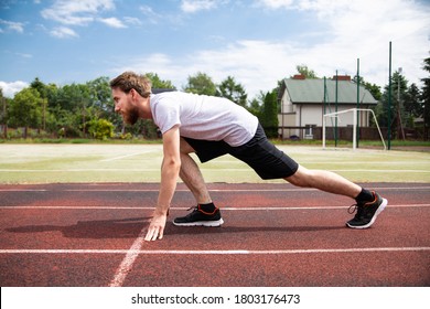 A Starting Position Of A Sprinter On A Running Track, Side View.