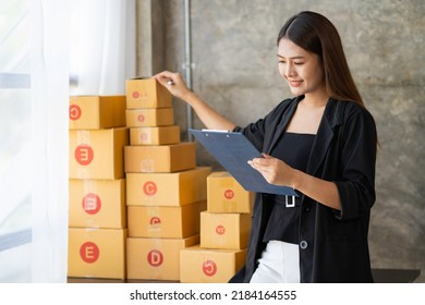 Starting Small Business Entrepreneur SME Freelance, Portrait Young Woman Check Stock On Clipboard And Parcel At Home Office,BOX,laptop, Online, Marketing, Packaging, Delivery, SME, E-commerce Concept