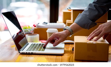 Starting small businesses SME owners man entrepreneurs Write the address on receipt box and check online orders to prepare to pack the boxes, sell to customers, sme business ideas online.